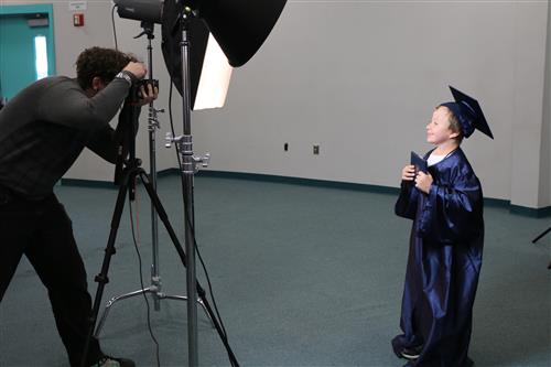 kindergartener in cap and gown